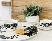 Load image into Gallery viewer, Designed to create a sophisticated affair is this NERI round platter from Salt&Pepper. Inspired by walks through sunlit forests, this lightweight 37x35cm platter features delicate silhouettes of leaves and foliage, creating an elegant yet modern effect.| Bliss Gifts & Homewares | Unit 8, 259 Princes Hwy Ulladulla | South Coast NSW | Online Retail Gift & Homeware Shopping | 0427795959, 44541523