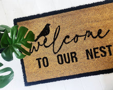 Load image into Gallery viewer, Our Welcome To Our Nest Door Mat is the perfect way to create a welcoming feel to your home before your guests even step foot inside with its beautiful design. Made from Natural coir fibres. PVC backing. Measures: 40x60x1.5cm.| Bliss Gifts & Homewares | Unit 8, 259 Princes Hwy Ulladulla | South Coast NSW | Online Retail Gift & Homeware Shopping | 0427795959, 44541523