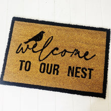 Load image into Gallery viewer, Our Welcome To Our Nest Door Mat is the perfect way to create a welcoming feel to your home before your guests even step foot inside with its beautiful design. Made from Natural coir fibres. PVC backing. Measures: 40x60x1.5cm.| Bliss Gifts & Homewares | Unit 8, 259 Princes Hwy Ulladulla | South Coast NSW | Online Retail Gift & Homeware Shopping | 0427795959, 44541523