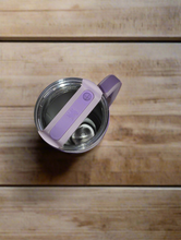 Load image into Gallery viewer, Reusable straw and splash-resistant lid on purple Stanley.

