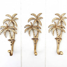 Load image into Gallery viewer, Our Islander Palm Tree Wall Hook has two brass swaying palm trees and a single hook. This little beauty is great to hang your keys, hat or towels. Our Islander Palm Tree Wall Hook comes with screws ready to hang. Add a touch of the tropics to your decor.| Bliss Gifts &amp; Homewares | Unit 8, 259 Princes Hwy Ulladulla | South Coast NSW | Online Retail Gift &amp; Homeware Shopping | 0427795959, 44541523