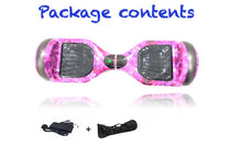 Load image into Gallery viewer, Pink hoverboard with package contents including a charger and key fob on a white background.